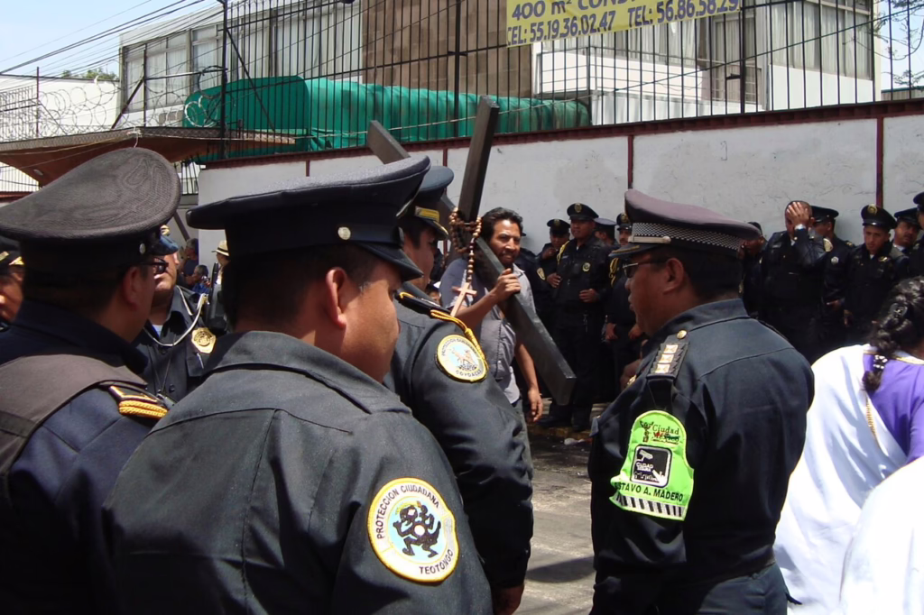 Police officers and security personnel managing the crowds during a Holy Week procession in Mexico.