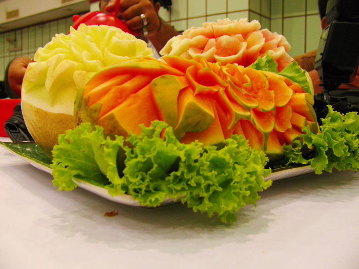 Beautifully carved papaya, watermelon, and honeydew melon garnished with lettuce. A true artistic touch in Singapore cuisine.
