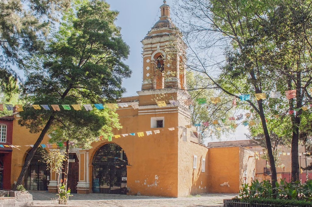 Historic church with stone walls and garden in Coyoacan, Mexico City
