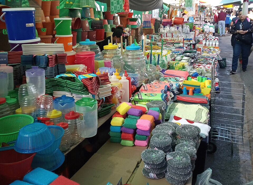 Colorful household items displayed at a tianguis market in Aguascalientes. The vibrant scene showcases everyday products for sale in an open-air market.