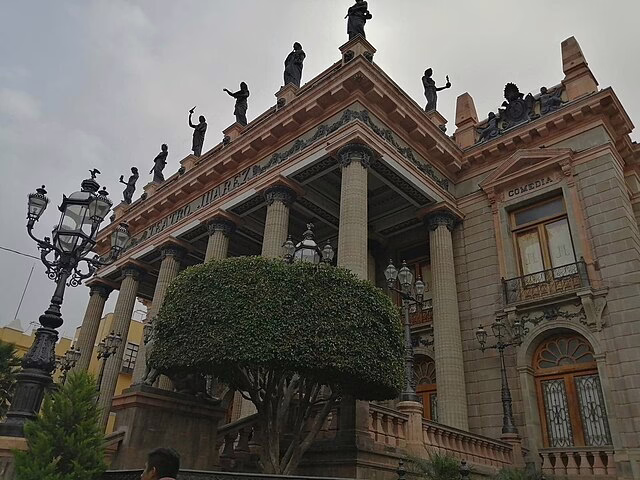 A grand shot of the Teatro Juarez in Guanajuato, with statues standing proudly above the entrance.