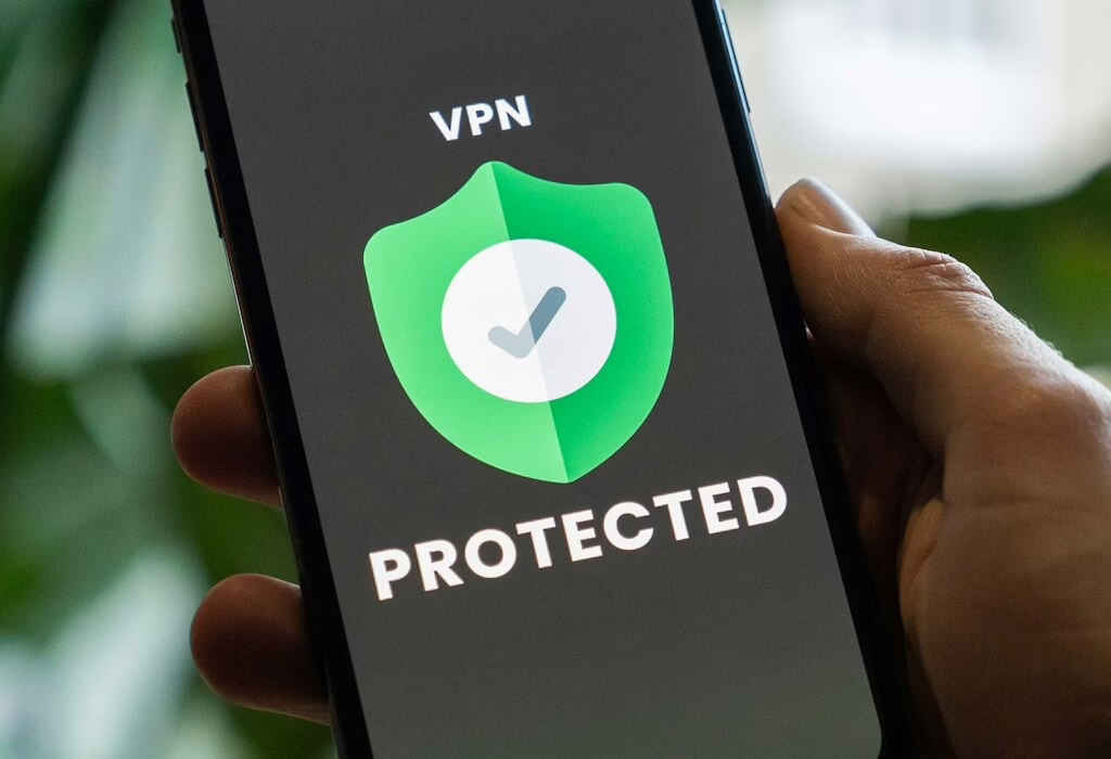 Close-up of a phone showing a VPN protected screen; traveler securing connection on public wifi to browse safely, protect data, and access services while traveling.