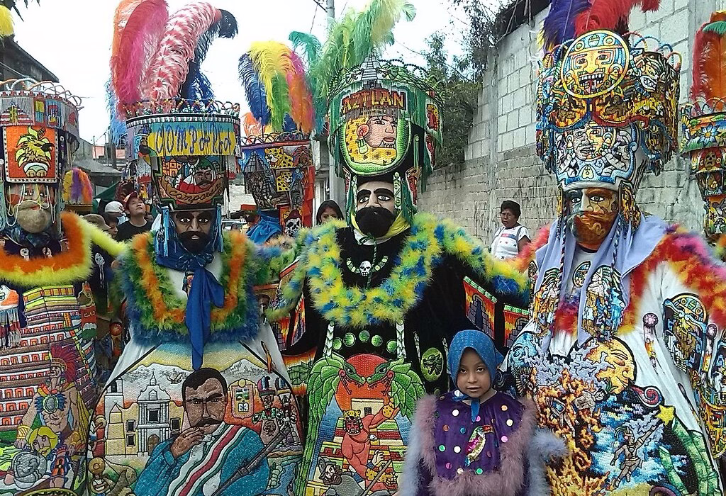 Colorful chinelos costumes with bright feathers and detailed art during a local parade in Mexico. fairs in mexico