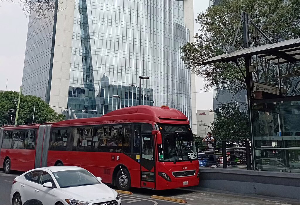 Red Metrobus at a station on Insurgentes Avenue in Mexico City, a fast transport for tourists.
