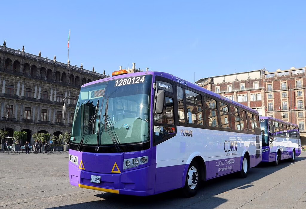 Purple and white CDMX public bus parked in the Zocalo main square of Mexico City. (traveling to mexico)