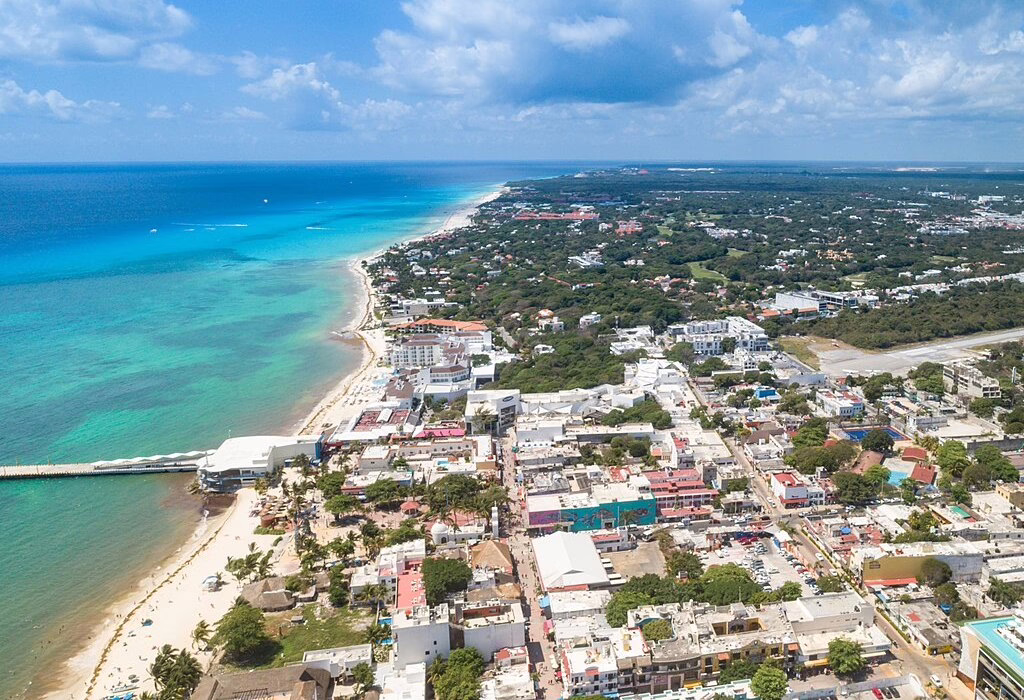Aerial view of a beachfront resort in Cancun with turquoise water and white sand, a safe destination for travelers visiting Mexico
