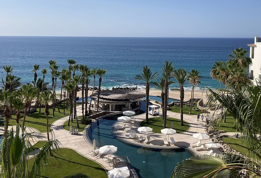 Oceanfront resort in Los Cabos with palm trees, pools, and open spaces, a safe destination in Mexico for travelers