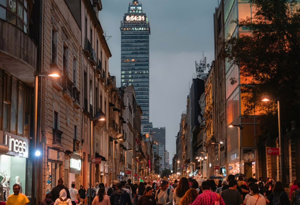 Busy pedestrian street in Mexico City at dusk, a lively and safe urban area for travelers exploring Mexico