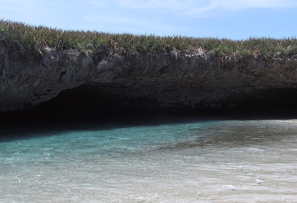 Clear shallow waters and volcanic rock overhang at Marietas Island near Puerto Vallarta inside a protected national park