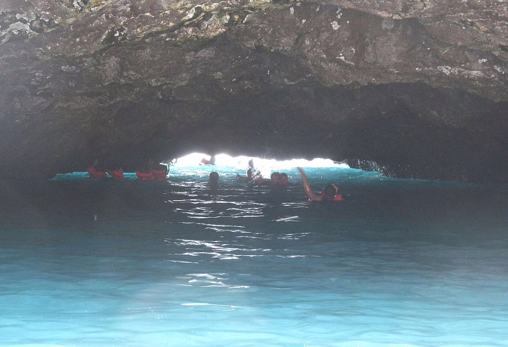 Visitors swimming through the natural tunnel to access the Hidden Beach at Marietas Islands