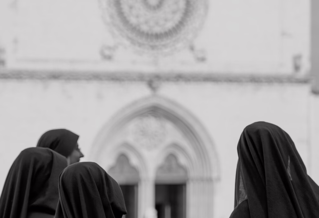 Nuns walking near the Basilica of St. Francis of Assisi, capturing the serenity of this sacred place and reflecting the deep spirituality of Assisi in Italy