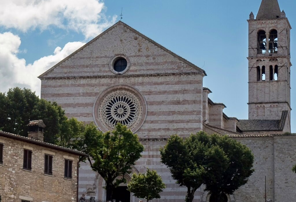 The stunning facade of the Basilica of St. Francis of Assisi, showcasing its iconic rose window and towering bell tower, a must-see in the heart of Assisi (the cathedral basilica of st francis of assisi photos)