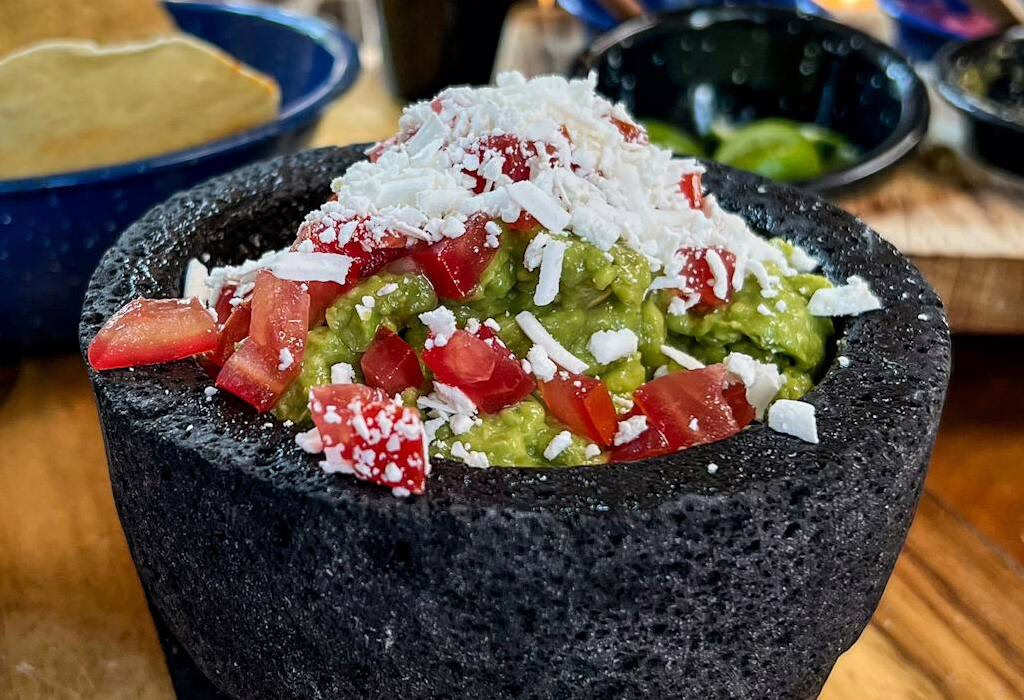 Green guacamole in stone bowl