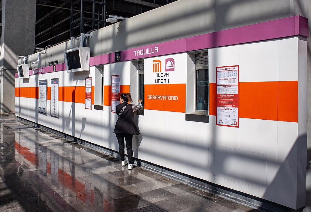 A woman at a Metro Mexico City ticket office (taquilla) in Observatorio station.