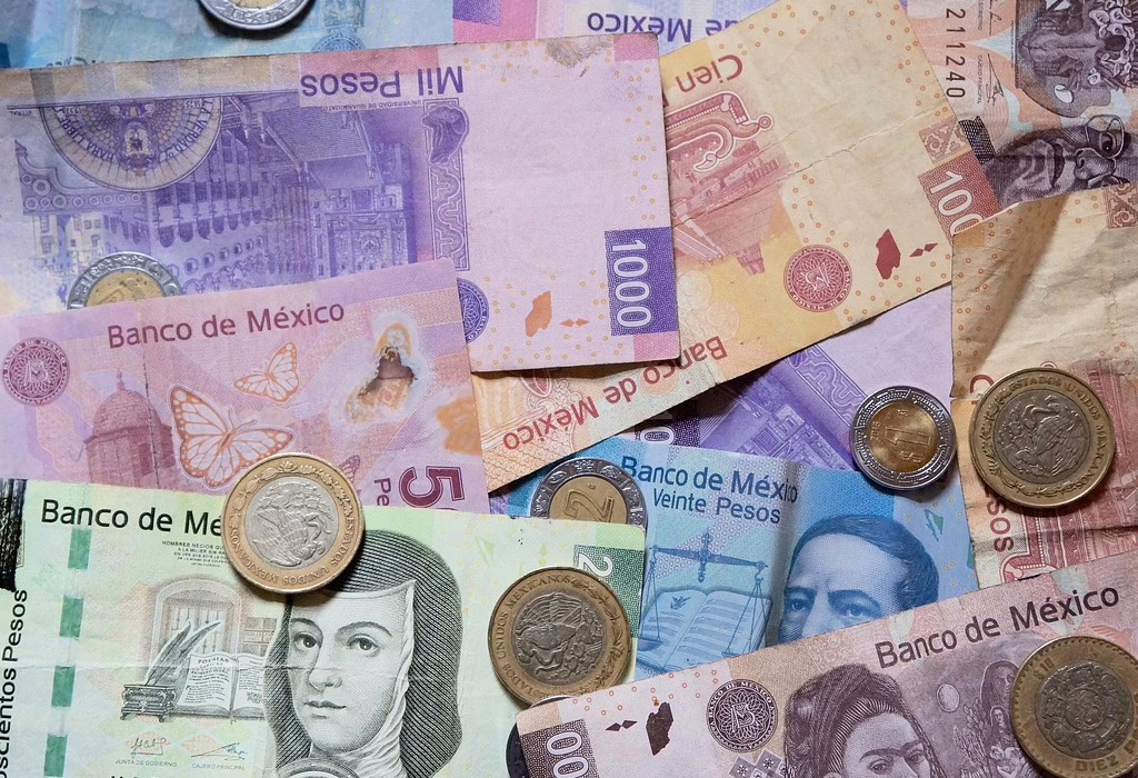 Mexican peso bills and coins, providing context on local currency and why Mexico City is safe for financial transactions.