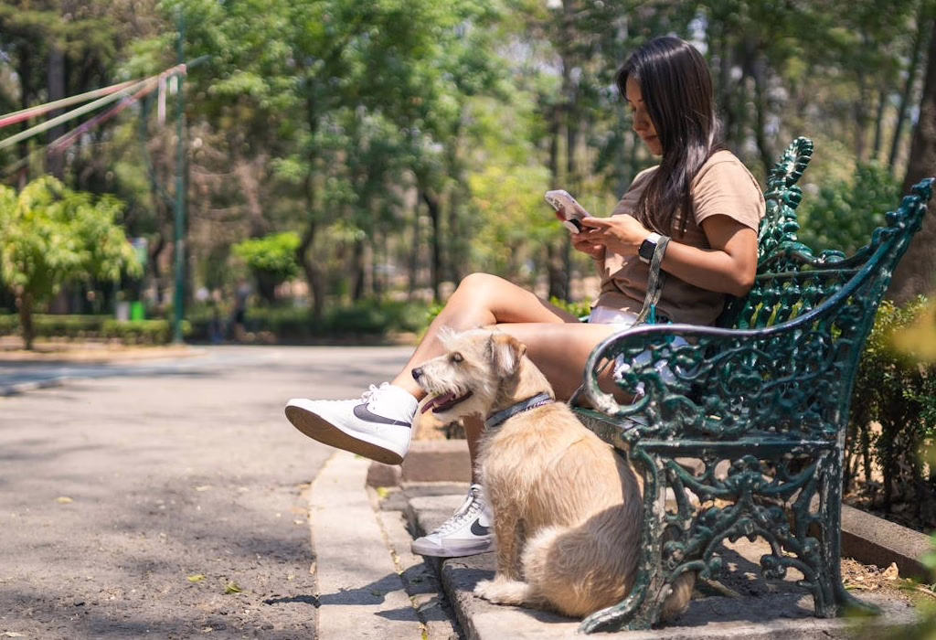 A woman relaxing with her dog in a Mexico City park, highlighting that Mexico City is safe for daily leisure activities.